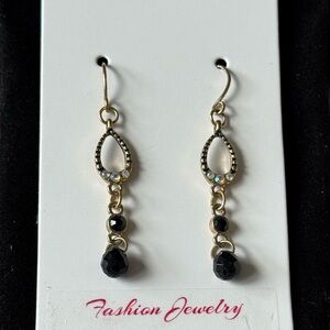 Gold tone drop earrings with sparkling stone and black beads.